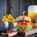 Beer and fresh hamburger made of beef, cheese and vegetables
