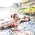 a lady sitting in a hot spring